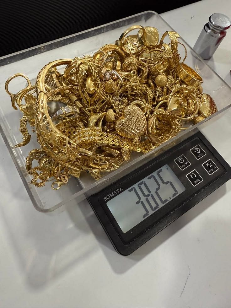 Gold pieces weighed on a digital scale